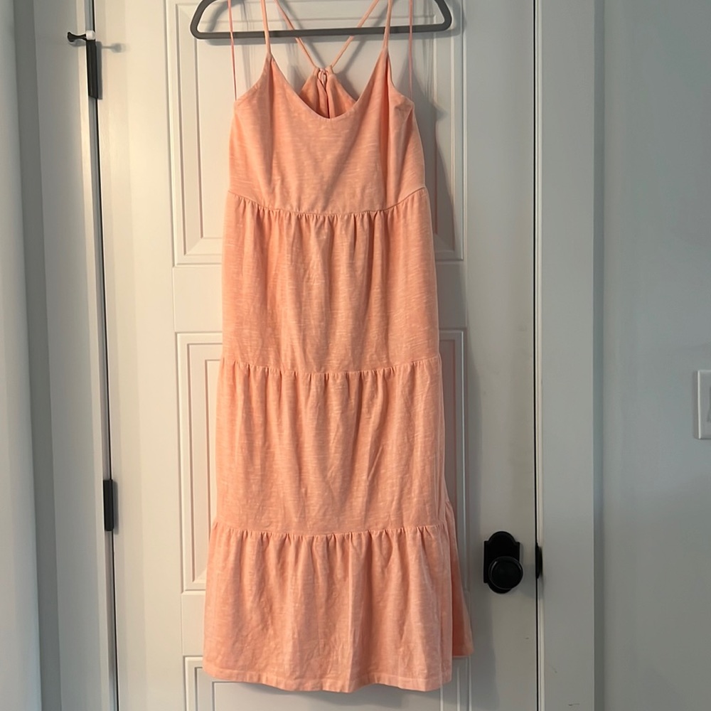 Peach tiered maxi dress with criss-cross back and scoop neck. POCKETS!